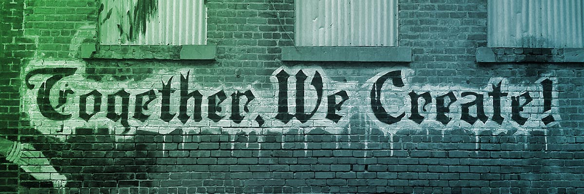 Brick wall with graffiti "Together we create"